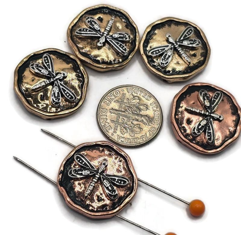 Crafted from durable metal, these beads feature intricate dragonfly details that bring elegance to any beading project.