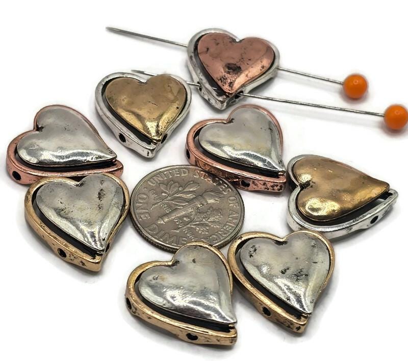Heart-shaped 2-hole metal slider beads are a perfect addition to any jewelry maker's collection.
These beads feature a unique heart design, making them ideal for creating romantic or personalized pieces of jewelry.