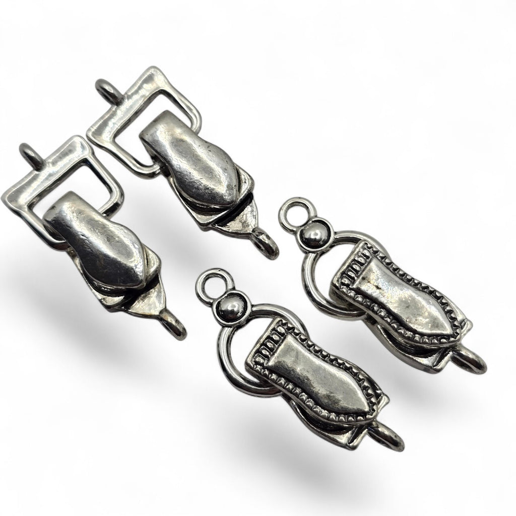 Mixed design silver fold-over magnetic clasps for jewelry making featuring two coordinating single-strand clasp styles. This four-piece assortment includes two of each silver metal design, with one attachment loop on each end for connecting beading wire or jewelry materials. Fold-over magnetic bracelet clasps combine convenient magnetic alignment with a hinged closure. Decorative jewelry findings for beaded bracelets, handmade jewelry, necklace making, DIY bracelet designs, and jewelry making at home.