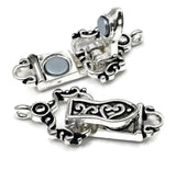 Set of decorative silver fold-over magnetic clasps arranged on a clean white background with soft shadows. The clasps feature intricate antique-inspired scrollwork and heart motifs on the front, complemented by detailed textured accents on the reverse side. These jewelry findings provide a secure and easy-to-use closure for bracelets, necklaces, and multi-strand jewelry designs. Suitable for bead weaving, stringing projects, and handcrafted accessories requiring both style and functionality.