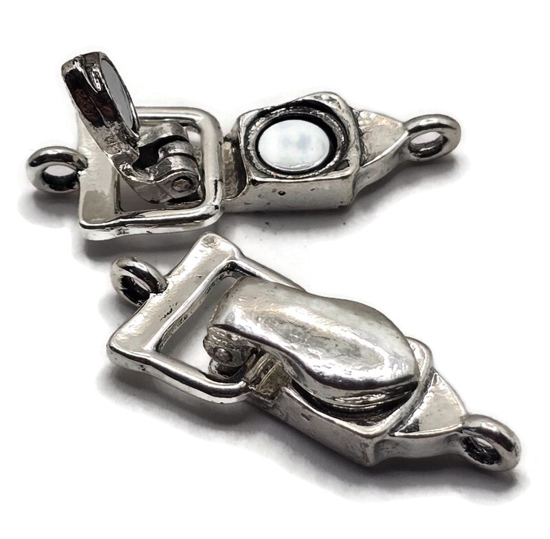 These weathered silver fold-over magnetic clasps feature a darker silver tone similar to stainless steel with irregular antiqued detailing for an aged appearance. Each clasp measures approximately 29 mm long and 12 mm wide with one vertical loop on each end. The magnetic closure and fold-over mechanism make these bracelet clasps easy to operate while providing a secure closure. Perfect for bead weaving, DIY bracelets, necklaces, gemstone jewelry, and handmade jewelry designs.