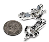 Decorative fold over magnetic clasp in polished silver with black enamel detailing throughout the ornamental design. The clasp features a secure hinged closure mechanism and strong magnetic connection for easy bracelet wear. One attachment loop is located on each end for simple integration into handmade bracelets, beading projects, leather jewelry, artisan creations, and custom jewelry making.