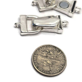 Bright silver magnetic fold over clasps photographed in open and closed positions to showcase the secure closure mechanism. The smooth polished finish complements both casual and elegant jewelry styles while providing dependable performance. Excellent for bracelet making supplies, jewelry findings, beading projects, leather jewelry, handcrafted accessories, and magnetic bracelet designs.