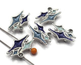 These unique 2 Hole Slider Beads feature a bold atomic star design accented with rich blue enamel and a sparkling clear rhinestone. Their vintage-inspired style makes them beautiful focal beads for bracelets, necklaces, earrings, and bead weaving projects. Pair them with crystals, pearls, natural stone beads, or leather to create eye-catching handmade jewelry with a fun retro flair.