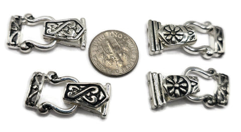Silver fold over magnetic clasps for bracelet designs, featuring two distinct decorative styles. Each clasp has two holes on each end for secure stringing and a cutout for knots or crimps. These magnetic clasps for jewelry making offer a reliable closure, easy to put on, and safer than open magnetic clasps. Ideal for necklaces, bracelets, and DIY jewelry components.