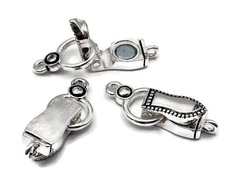 Silver fold over magnetic clasps with loops oriented opposite directions. Magnetic bracelet clasps for single strand or multi strand beading projects. Use as bracelet clasps, necklace clasps, and magnetic jewelry clasps for stringing and bead weaving. Foldover lock covers the magnet for a secure closure. Ideal magnetic clasps for bracelet designs, DIY jewelry making, and double‑use magnetic necklace clasps.