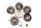 These spiral 2-hole slider beads feature antiqued silver centers with warm copper edges, creating a rustic artisan look. The swirling spiral design is symbolic of growth, energy, and creativity. With dual-hole construction, these beads stay flat and aligned in bracelets, chokers, or layered necklaces. Perfect for boho, Southwestern, or tribal-style jewelry, they make meaningful and stylish focal components for artisan creations.