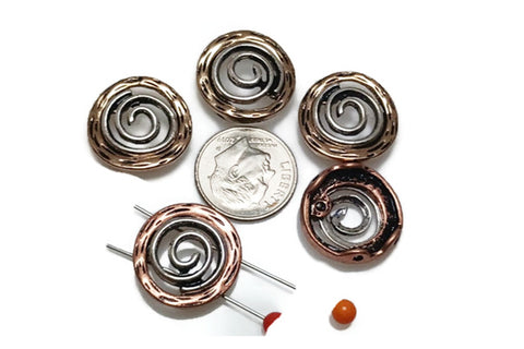 These spiral 2-hole slider beads feature antiqued silver centers with warm copper edges, creating a rustic artisan look. The swirling spiral design is symbolic of growth, energy, and creativity. With dual-hole construction, these beads stay flat and aligned in bracelets, chokers, or layered necklaces. Perfect for boho, Southwestern, or tribal-style jewelry, they make meaningful and stylish focal components for artisan creations.
