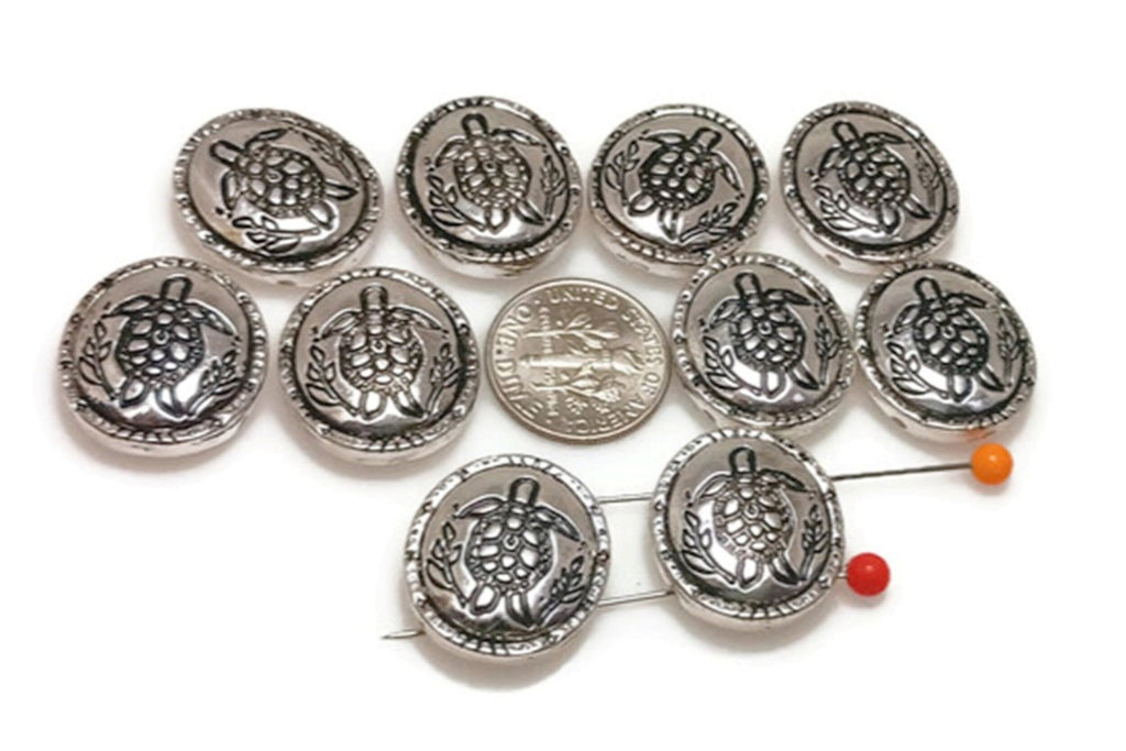 Add nautical charm to your jewelry projects with these silver two-hole sea turtle slider beads. Featuring a detailed turtle engraving surrounded by ocean-inspired designs, they are perfect for bracelets, anklets, and necklaces. Durable and lightweight, these beads stay secure thanks to their slider design. Ideal for coastal jewelry, boho collections, and meaningful gifts for ocean lovers and turtle enthusiasts alike.