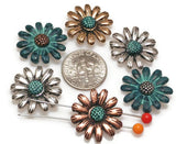 These daisy sliders bring cheerful, botanical flair to double‑strand bracelets. The domed petals and oxidized shadows create depth without bulk. Mix silver, copper, and patina finishes for boho bouquets, or spotlight one bloom as a focal slider on a choker. Great components for festival jewelry, teacher gifts, and nature‑inspired sets.