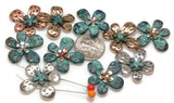 These double-hole floral beads are available in silver, gold, patina, and copper finishes, making them versatile for bracelet and necklace projects.