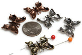 Design jewelry that takes flight with these filigree butterfly slider beads. Finished in antique silver, copper, and brass, each bead has two parallel holes for stable alignment in multi‑strand bracelets and necklaces. Their symbolic meaning of transformation, joy, and freedom makes them popular for artisan, boho, and spiritual jewelry alike. Use them as eye‑catching focal connectors in handmade pieces.