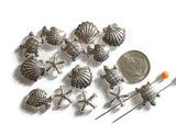 Design coastal jewelry with these antique silver sea life slider beads. Featuring finely detailed turtles, shells, starfish, and fish, each bead adds rustic ocean beauty to artisan creations. With 2-hole slider construction, strands stay aligned and secure for chokers, cuffs, and statement necklaces. Great for boho jewelry, nautical accessories, or personalized handmade gifts for ocean enthusiasts.