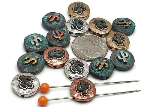 Southwest cactus beads, 2 hole slider style, in mixed metals. Round coin profile with raised saguaro cactus and rustic texture. Finishes include antique silver, warm copper, vintage brass, and turquoise verdigris patina. Unique beads that make great focal beads for bracelet designs and simple pendant accents on necklaces. Keywords: cactus bead, desert bead, southwestern beads, boho western jewelry supplies.
