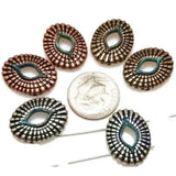 These oval 2-hole slider beads bring rustic charm to boho and tribal jewelry. Crafted in antique silver, bronze, and copper finishes with turquoise patina accents, each bead features a textured scale-like pattern and open center design. The dual-hole construction keeps strands aligned, making them perfect for chokers, bracelets, or layered necklaces. Great for artisan jewelry with Southwestern or earthy inspiration.