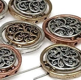 These decorative round slider beads feature an openwork filigree design, making them lightweight yet visually striking.