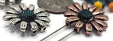 These floral sliders make photo‑ready jewelry with minimal effort. The petals catch the light, while the dark antiquing emphasizes texture. Use as a bracelet centerpiece framed by gemstone rounds or seed‑bead rings, or line several across a pendant bar for a bouquet necklace. Perfect for spring collections and cottagecore gifts.