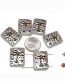 These dragonfly slider beads bring rustic elegance to your jewelry creations. Rectangular in shape with antique silver bases, each bead features a raised dragonfly highlighted in bronze and copper tones against a starry-textured backdrop. With 2-hole slider construction, they stay flat and secure in chokers, bracelets, or necklaces. Perfect for boho designs, symbolic jewelry, and handmade gifts inspired by nature’s beauty and transformation.