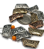 Sculpted 2‑hole beads—curved bar silhouette with etched chevrons and dots. Mix the silver, brass, and copper tones for layered boho bracelets or a simple choker centerpiece. The double‑strand design keeps your strands parallel and prevents twisting, delivering a clean, professional finish for quick‑sell jewelry.