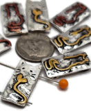 Whimsical metal cat slider beads with two holes for easy stringing, featuring sweet embossed faces and tails shaped into hearts. Perfect focal beads and spacers for DIY jewelry projects.