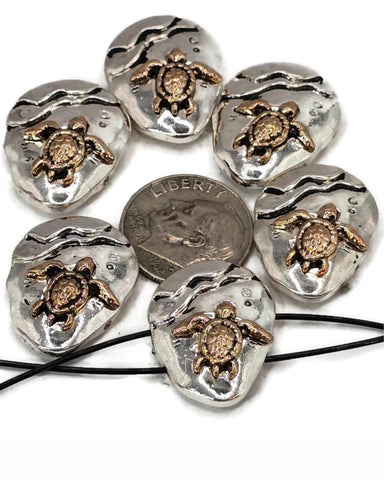 Beautiful sea turtle 2 hole slider beads crafted in silver-tone metal with bronze turtle detailing. These round beads sit flat and secure, making them perfect as focal beads for ocean jewelry, seaside bracelets, beach necklaces, and nautical handmade designs.