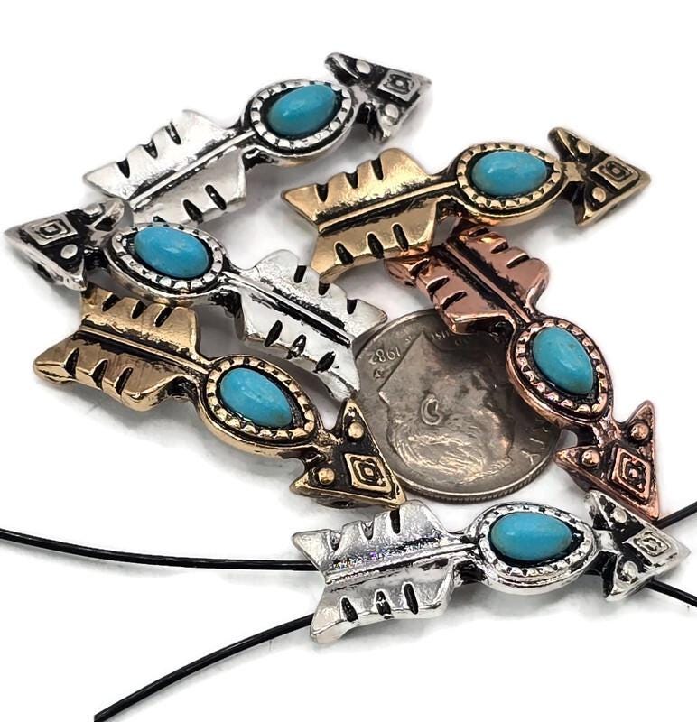 These arrow 2 hole slider beads with faux turquoise centers are perfect focal pieces for bracelets, necklaces, and chokers. Each bead features a rustic arrow design finished in silver, gold-bronze, and copper tones, bringing Western and bohemian flair to your DIY projects. The two-hole structure ensures a flat, stable fit. Ideal for jewelry makers crafting boho, Southwestern, tribal, or cowboy-inspired handmade jewelry.