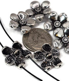These flower 2 hole slider beads feature a five-petal design with embossed details and silver-tone finish. Perfect as focal beads for bracelets, necklaces, or chokers, they sit flat and secure thanks to their two-hole structure. Durable and lightweight, these metal beads add a touch of whimsical floral charm to boho, rustic, or romantic handmade jewelry projects. Ideal for artisans and crafters looking for versatile floral jewelry findings.