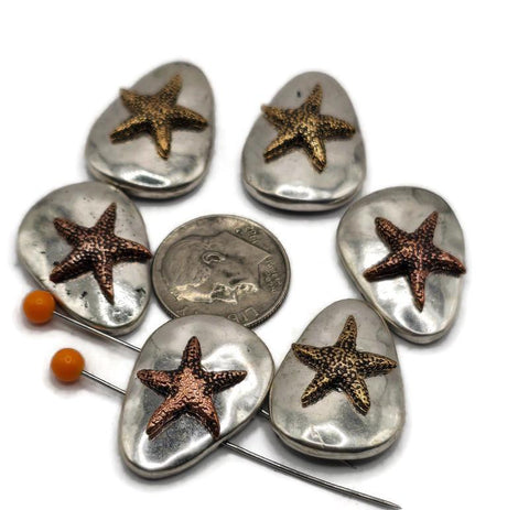 These oval starfish 2 hole slider beads are perfect for beach and nautical jewelry designs. Featuring raised copper or gold-tone starfish on smooth silver bases, each bead brings coastal charm to bracelets, chokers, and pendants. The two-hole layout ensures beads sit flat and secure, giving your creations a professional finish. Ideal as focal beads or spacers, they complement shells, gemstones, and leather cords beautifully for ocean-inspired handmade jewelry.