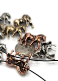 These Western horse slider beads are cast with intricate detailing and finished in antique silver, warm bronze, and copper tones. Measuring about dime-size, they make bold focal pieces in bracelets, chokers, or necklaces. Their two-hole slider layout ensures stability and ease of use in leather wrap or multi-strand jewelry. Symbolizing strength, courage, and freedom, these beads are perfect for rodeo, ranch, cowboy, and equestrian jewelry projects.