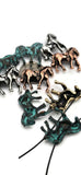 Bring the spirit of the West into your beadwork with these horse 2 hole slider beads, finished in mixed metallic and turquoise patina tones. Their galloping horse design makes them outstanding focal beads for bracelets, necklaces, and chokers. With strong two-hole slider construction, these beads stay flat and secure in your jewelry, offering professional stability. Perfect for cowboy, equestrian, or rustic Western jewelry, they capture motion and strength in every handmade creation.