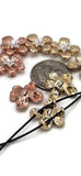 Add floral charm to your creations with these hammered metal flower slider beads in gold and copper. Each bead has detailed silver centers for added contrast and shine. The dual-hole structure keeps beads flat, ideal for multi-strand designs, bracelets, and pendants. Lightweight but durable, these beads are great for bohemian, nature, and artisan handmade jewelry.