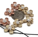 Rustic yet charming, these hammered flower slider beads feature silver centers paired with gold and copper petals. Each bead has two holes to ensure secure and flat placement in bracelets, pendants, and chokers. Their floral shape captures garden elegance while the design’s durability makes them versatile for creations in boho, rustic, or romantic handmade jewelry.