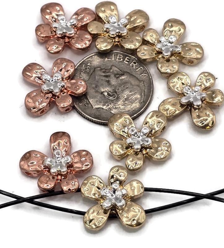 These flower 2 hole slider beads feature hammered metal petals in gold and copper tones, highlighted with silver accents at the center. Their two-hole design ensures secure, flat fitting in bracelets, chokers, and necklaces. Great as focal beads or decorative spacers, they’re perfect for artisans crafting boho, romantic, or garden-inspired jewelry with elegance and durability.