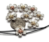 These flower-shaped slider beads showcase textured silver petals paired with gold- or copper-tone centers, offering both depth and elegance. Lightweight and durable, they’re perfect for bracelets, multi-strand necklaces, and chokers. Their two-hole slider design ensures beads lie flat for a polished, stable look. Great for makers seeking boho chic or rustic floral supplies.