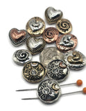 This collection of two-hole slider beads features hearts, spirals, and celestial sun & moon designs with rhinestones. Each bead has antique silver, bronze, or copper finishes that add rustic elegance to boho and artisan jewelry. Perfect for bracelets, necklaces, and anklets, these versatile beads capture meaningful symbols and timeless style for your handmade jewelry projects.