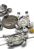 Design stunning handmade jewelry with these antique silver sea turtle slider beads. Each bead is shaped into a turtle with a spiral shell and textured tribal-style details, giving a unique ocean-inspired look. With two holes on the back, they work beautifully for multi-strand necklaces, bracelets, and leather cord chokers. Perfect for boho festival jewelry, coastal accessories, or nautical gifts, these turtle beads are a must-have for jewelry makers who love beachy designs.