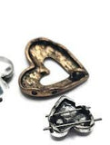 These mixed-metal heart slider beads bring rustic romance to handmade jewelry. Featuring antique silver, bronze, and copper tones, the set includes both open-cut hearts and layered heart motifs with fine detailing. The dual-hole construction secures strands flat and stable, making them perfect for artisan bracelets, chokers, and necklaces. Ideal for bohemian jewelry collections, meaningful gifts, and romantic designs with vintage charm.