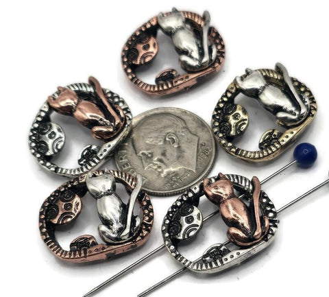 These cat and moon 2-hole slider beads are perfect for mystical and bohemian jewelry. Each oval bead features a sitting cat gazing at the moon, finished in antique silver, copper, or bronze with artisan detailing. The dual-hole slider design keeps strands flat and secure, making them ideal for chokers, bracelets, or necklaces. Great for cat lover jewelry, boho accessories, or whimsical handmade gifts.