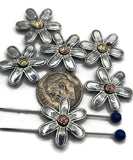 These daisy flower slider beads add a cheerful, rustic touch to handmade jewelry. Each bead features detailed silver petals with a spiral center in gold or copper tone, creating a unique artisan look. Perfect for threading onto wire, cord, or beaded strands, they are ideal for bracelets, necklaces, and DIY crafts. Durable and versatile, they bring timeless floral charm to your jewelry designs.