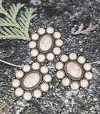 Give your jewelry a touch of bold artisan charm with these oval slider beads. Featuring a white faux howlite stone in the center framed by petite cabochons, each bead is detailed with silver accents for added texture. Two parallel holes ensure smooth alignment in designs, making them excellent for structured bracelets or necklace focal points in bohemian or vintage-inspired jewelry.