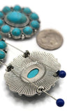 These ornate turquoise cabochon slider beads are ideal for artisan jewelry. The large oval faux turquoise stone is accented by a ring of smaller cabochons, framed by antique silver rope detailing. With two holes for structure, these beads align beautifully in chokers, statement necklaces, or multi-strand bracelets. Perfect for Southwestern, Native-inspired, or bohemian jewelry pieces that call for striking focal components.