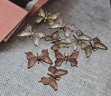 Flutter into creativity with these mixed‑finish butterfly two‑hole slider beads. Featuring antique silver, brass, and copper tones, each bead showcases intricate cutout wings that capture natural beauty. Their dual‑hole design provides stability for multi‑strand projects, making them perfect as focal links or connectors in bracelets and chokers. Symbolizing transformation and freedom, they bring meaningful charm to handmade jewelry.