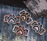 Honor the bond between humans and animals with these paw print two‑hole beads. Each bead features a paw motif in antique copper, silver, or brass, framed with rustic style. Their double side holes allow them to align neatly in multi‑strand jewelry projects. Perfect for focal beads in animal‑themed jewelry, pet owner gifts, memorial designs, or artisan handcrafted pieces.