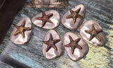 Design meaningful coastal jewelry with these starfish two‑hole beads. Each features a textured bronze starfish set atop a smooth silver pebble base for artisan charm. Dual side holes ensure the bead stays aligned in bracelet or pendant necklace designs. Perfect as beachy focals, these slider beads bring nautical style and organic artistry to summer jewelry and handmade artisan creations.
