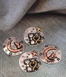 Celebrate cats and celestial style with these crescent moon beads. Featuring starry backgrounds, heart details, and a sitting cat, each piece combines antique silver with copper and golden accents. Their artisan design makes them standout focal beads for necklaces or pendants, but they also fit beautifully in bracelets. Perfect for pet lovers, spiritual jewelry designers, or mystical artisan creations.