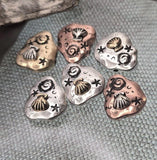 These seashell 2‑hole slider beads combine rustic artisan style with beach vibes. Sculpted with raised seashells, spirals, and stars, each bead is finished in antique copper, silver, or brass. Dual side holes hold them steady as focal beads for bracelets, layered pendants, or chokers. Perfect artisan jewelry components for nautical, summer, or ocean‑inspired handmade gift collections.
