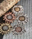 These sunflower beads add cheerful floral style to handmade jewelry. Crafted in antique finishes of copper, silver, and brass, they resist tarnishing and wear. Their large size, realistic center, and textured petals make them perfect focals for necklaces or pendants. Lightweight yet durable, they’re artisan quality supplies ideal for rustic, bohemian, and nature‑inspired jewelry collections.