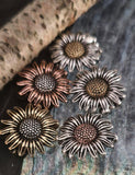 These sunflower beads make stunning focal components for necklace and pendant jewelry designs. Crafted in non‑tarnish antique brass, copper, and silver finishes, they maintain beauty without fading or wearing down. Their bold size highlights intricate petal detail and artisan craftsmanship, creating rustic, bohemian, or botanical statement jewelry. Perfect choice for handmade gifts, boutique collections, or keepsakes inspired by nature.