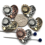 These sunflower heart-shaped slider beads are perfect for statement focal jewelry. Crafted with exquisite sunflower detail and floral accents, they’re available in antique copper, silver, and brass finishes designed not to tarnish. Dual holes ensure stability in multi-strand designs, making them versatile for bracelets or pendants. Great for artisan floral jewelry, rustic gifts, or bohemian collections celebrating nature’s beauty.