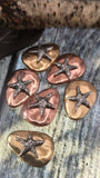 These ocean‑themed starfish slider beads make perfect focal pieces for artisan jewelry. Crafted in durable brass and copper finishes, each bead features a textured silver starfish on a pebble‑like background. Stable two‑hole threading keeps them aligned in bracelets, pendants, or necklaces. Great choice for handmade boho, nautical, or beach collections full of rustic charm and coastal artistry.